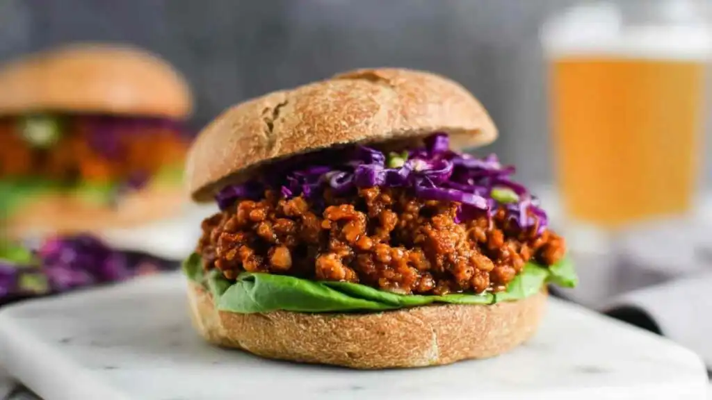 BBQ Lentil Sloppy Joes 19 BBQ lentil sloppy joes piled onto a toasted whole wheat bun with shredded red cabbage and sliced avocado
