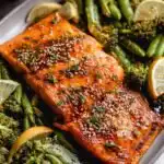 Baked miso salmon fillet with caramelized miso glaze on a sheet pan with roasted broccoli, edamame, and carrots