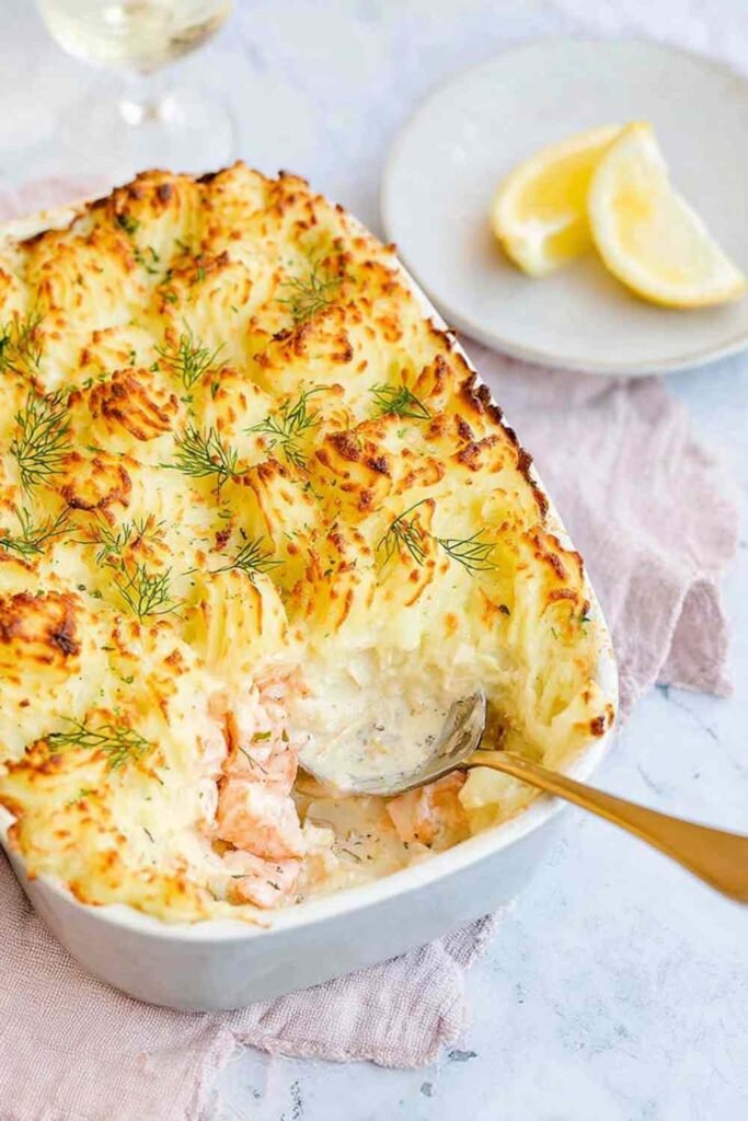 Best Ever Fish Pie 26 Golden best ever fish pie with cheesy mashed potato topping fresh out of the oven in a white ceramic baking dish