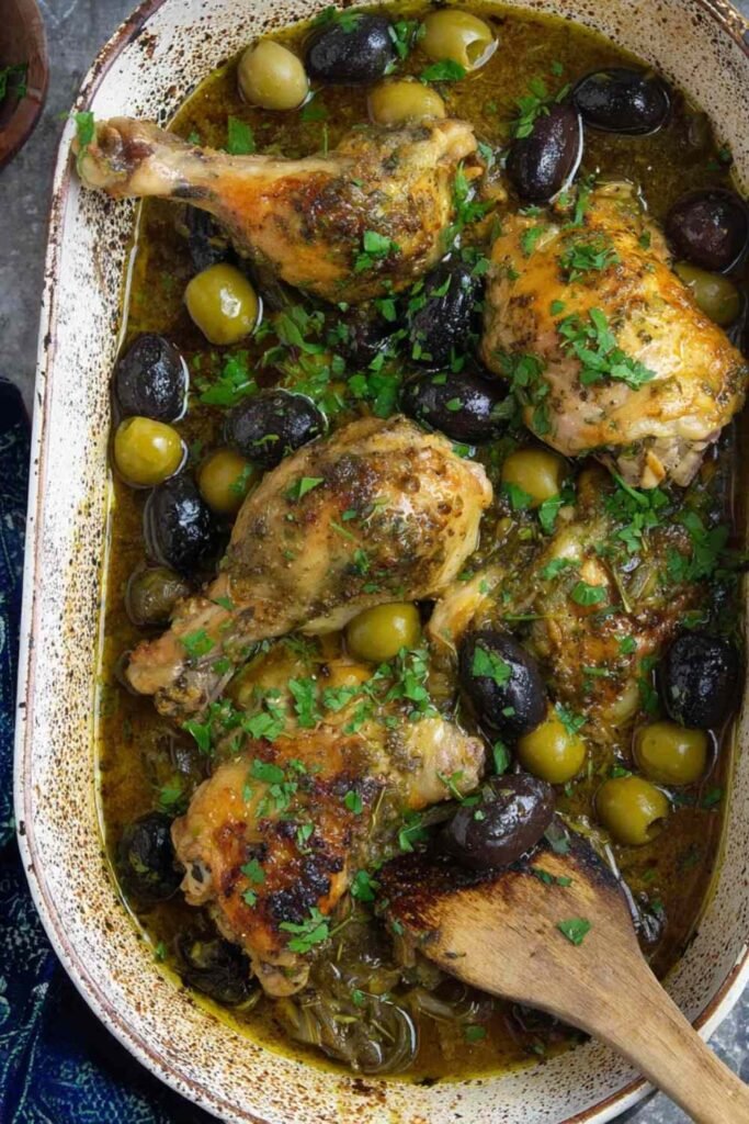 High Protein Chicken Marbella 20 High protein Chicken Marbella recipe served on a white platter with prunes, olives, capers, and fresh parsley garnish