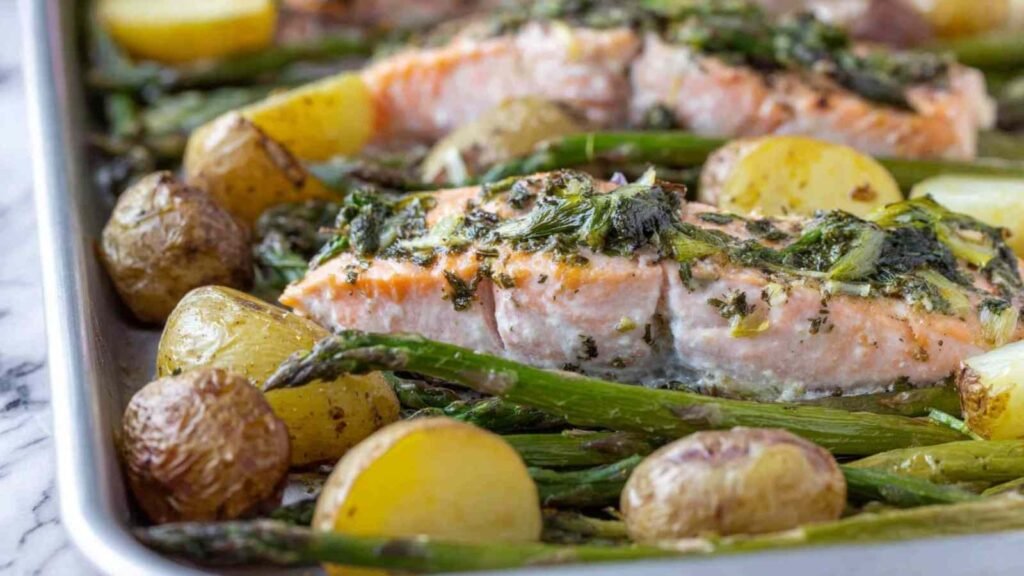 Easy salmon broccoli and potatoes on a sheet pan with asparagus and butter beans in a lemon-mustard marinade