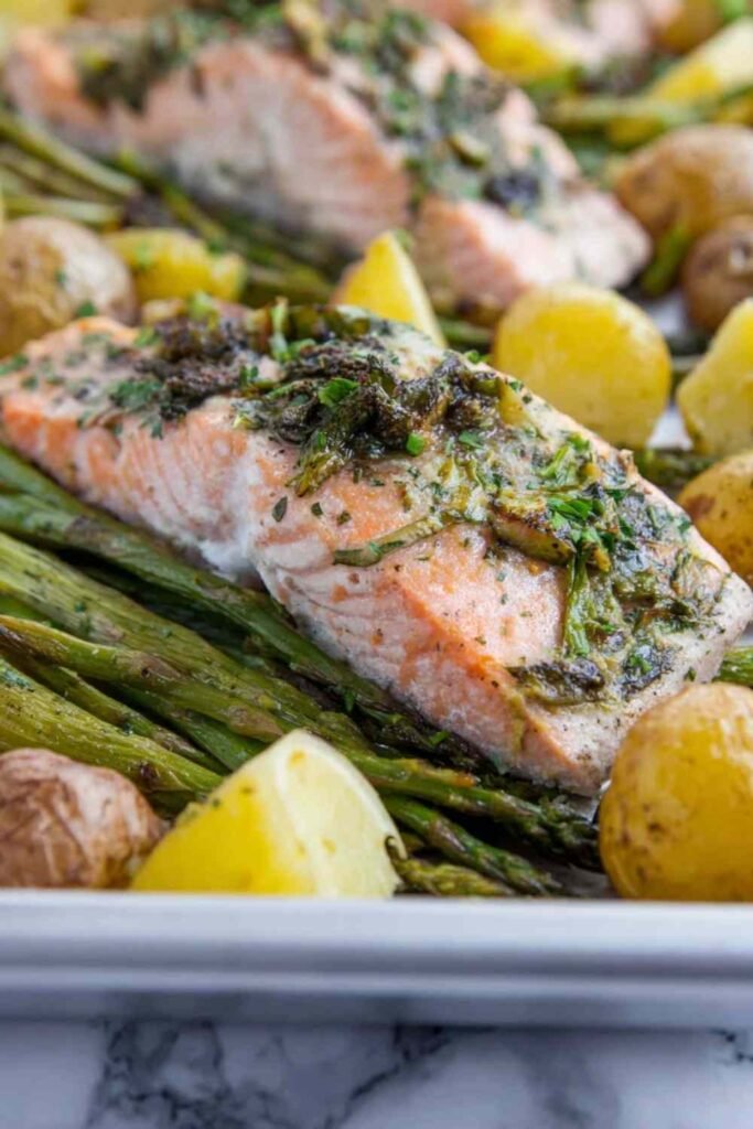 Easy salmon broccoli and potatoes on a sheet pan with asparagus and butter beans in a lemon-mustard marinade