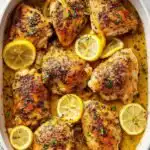 Greek Lemon Chicken 3 Greek lemon chicken high protein recipe baked golden in a casserole dish with lemon slices and fresh herbs