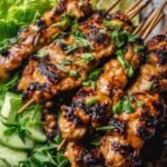 Grilled Vietnamese Chicken (Ga Nuong Sa) 18 Grilled Vietnamese Chicken thighs with caramelized lemongrass honey glaze, garnished with fresh cilantro and lime wedges on a white plate
