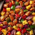 Hawaiian Chicken Sheet Pan 9 Hawaiian Chicken Sheet Pan with golden chicken pieces, caramelized pineapple chunks, and colorful bell peppers on a parchment-lined pan