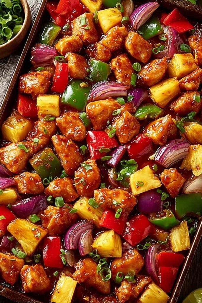 Hawaiian Chicken Sheet Pan 8 Hawaiian Chicken Sheet Pan with golden chicken pieces, caramelized pineapple chunks, and colorful bell peppers on a parchment-lined pan