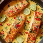 Poached Salmon in Coconut Lime Sauce 3 Overhead view of poached salmon in coconut lime sauce served over jasmine rice with steamed bok choy and fresh cilantro