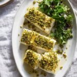 Quick Baked Fish with Bread Crumbs and Herbs 27 Quick baked fish with bread crumbs and herbs on a parchment-lined baking sheet with golden herb crust fresh out of the oven