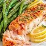 Salmon and Green Beans Sheet Pan Dinner 18 Overhead view of salmon and green beans sheet pan dinner with four seasoned fillets and roasted green beans on a parchment-lined baking sheet