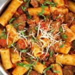 Spicy sausage pasta with rigatoni in a rich crushed tomato sauce with mushrooms and red bell pepper
