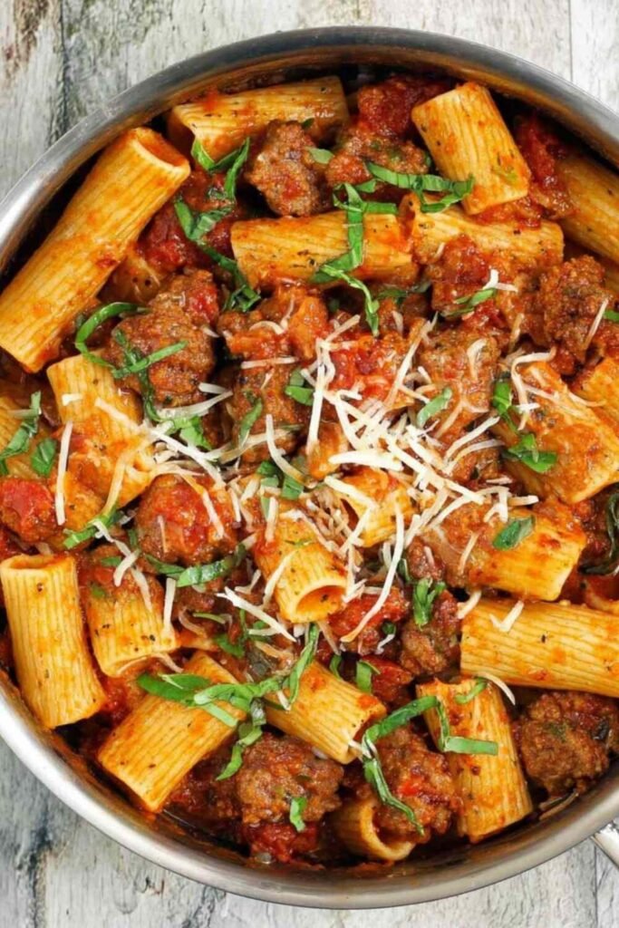 Spicy sausage pasta with rigatoni in a rich crushed tomato sauce with mushrooms and red bell pepper