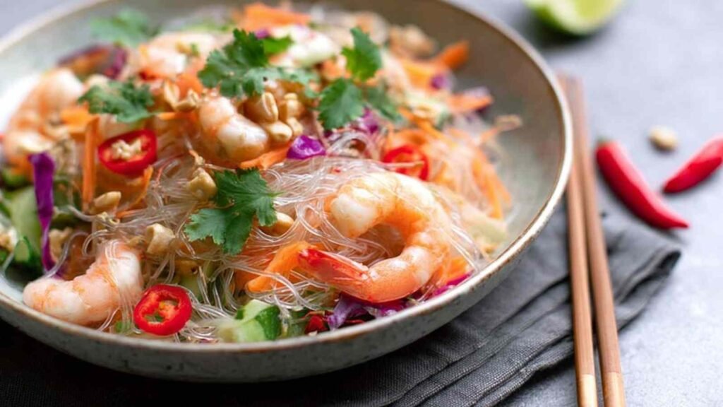 Yum Woon Sen (Thai Glass Noodle Salad) 1 Yum Woon Sen Thai glass noodle salad with wild prawns, pork, cashews, and fresh cilantro served in a large white dish