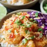 Bang Bang Shrimp Rice Bowls 15 Assembled Bang Bang Shrimp Rice Bowl topped with creamy bang bang sauce, shredded cabbage, diced tomatoes, and green onion