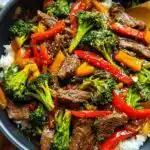 Easy Beef Stir Fry 6 Easy beef stir fry recipe with tender sirloin, broccoli, red pepper, and baby corn served over steamed white rice, garnished with sesame seeds