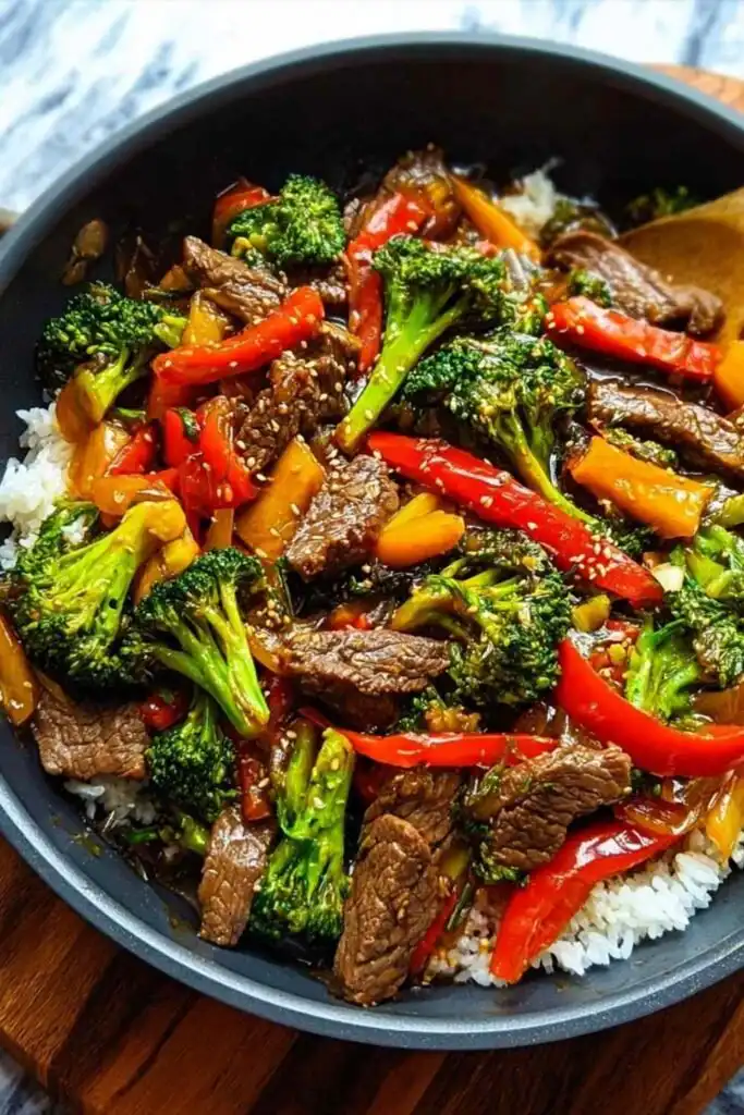 Easy Beef Stir Fry 5 Easy beef stir fry recipe with tender sirloin, broccoli, red pepper, and baby corn served over steamed white rice, garnished with sesame seeds