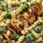 Quick and Easy High Protein Rotisserie Chicken Broccoli Pasta 3 High protein rotisserie chicken broccoli pasta in a large skillet topped with Parmesan and fresh parsley