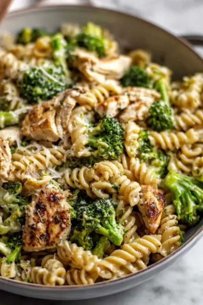 High Protein Rotisserie Chicken Broccoli Pasta 2 High protein rotisserie chicken broccoli pasta in a white bowl with creamy Parmesan sauce