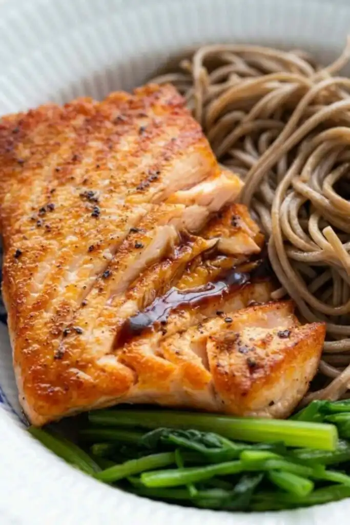 High-Protein Lemon Blueberry Overnight Oats 2 Salmon soba noodle salad with crispy skin salmon, buckwheat soba noodles, blanched spinach, and ginger dressing in a white bowl