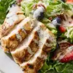Copycat Panera Strawberry Poppyseed Chicken Salad 15 Copycat Panera Strawberry Poppyseed Chicken Salad on a white plate with sliced grilled chicken, fresh strawberries, blueberries, toasted pecans, and creamy poppy seed dressing